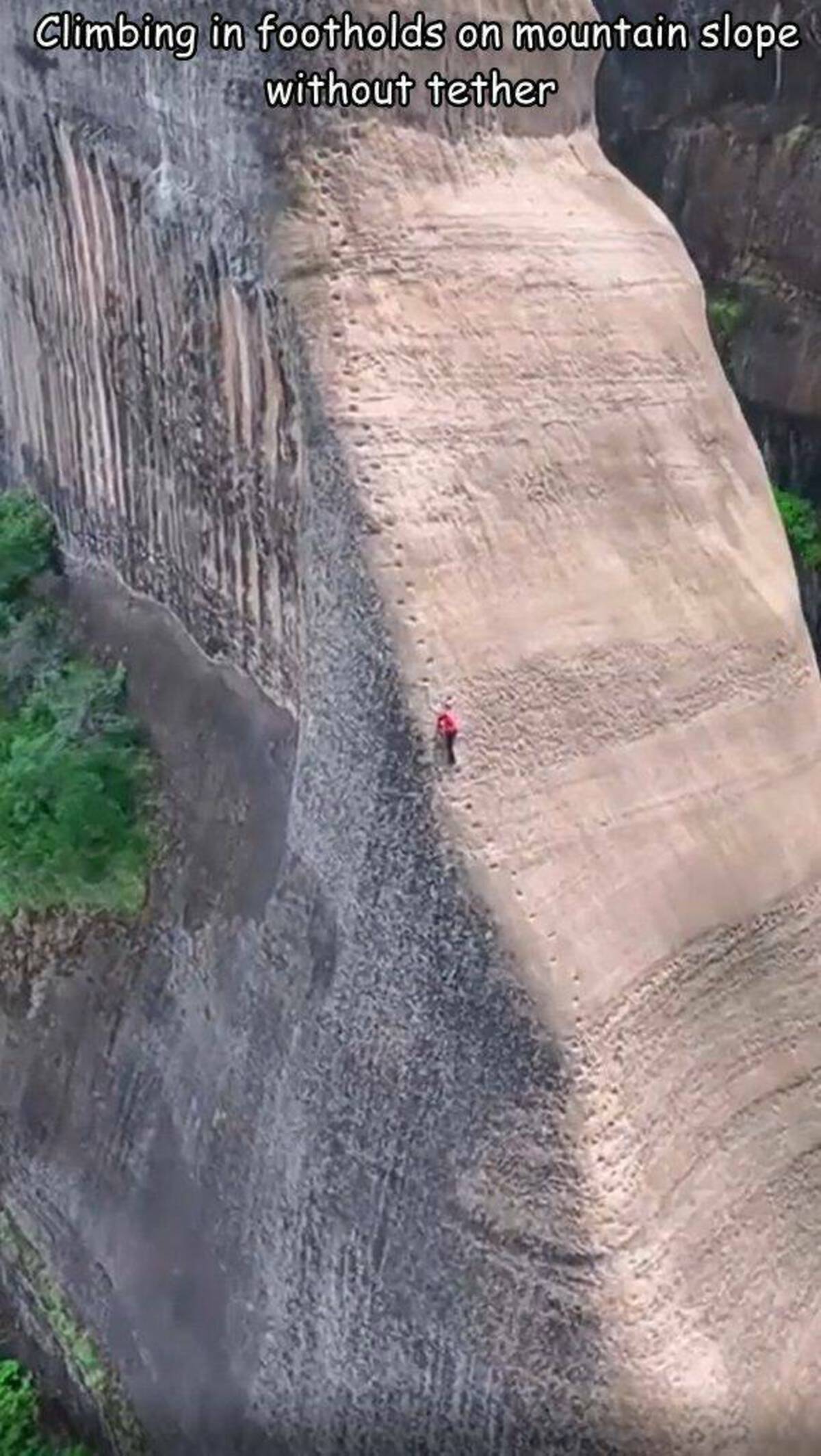 waterfall - Climbing in footholds on mountain slope without tether