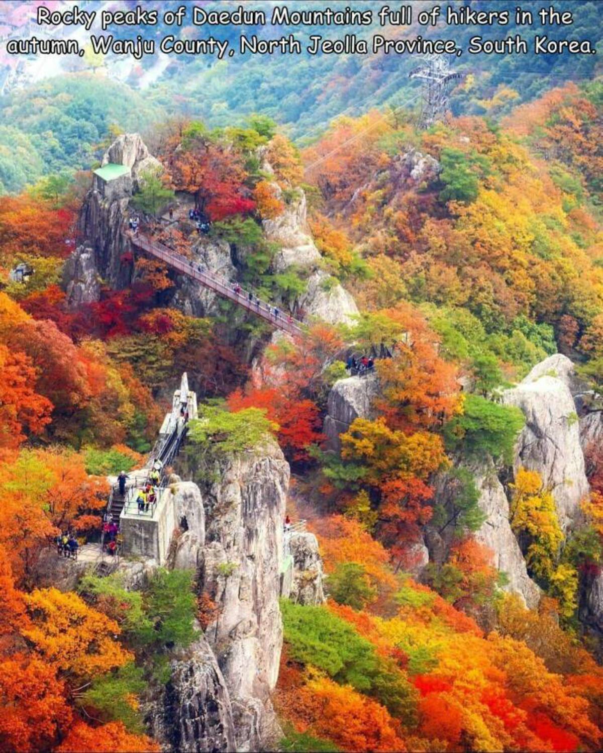 maple - Rocky peaks of Daedun Mountains full of hikers in the autumn, Wanju County, North Jeolla Province, South Korea.