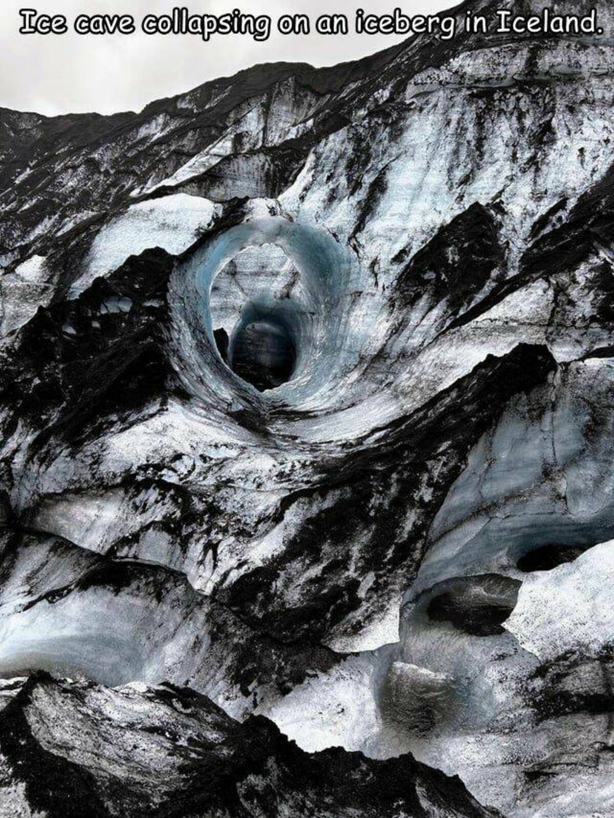 outcrop - Ice cave collapsing on an iceberg in Iceland.