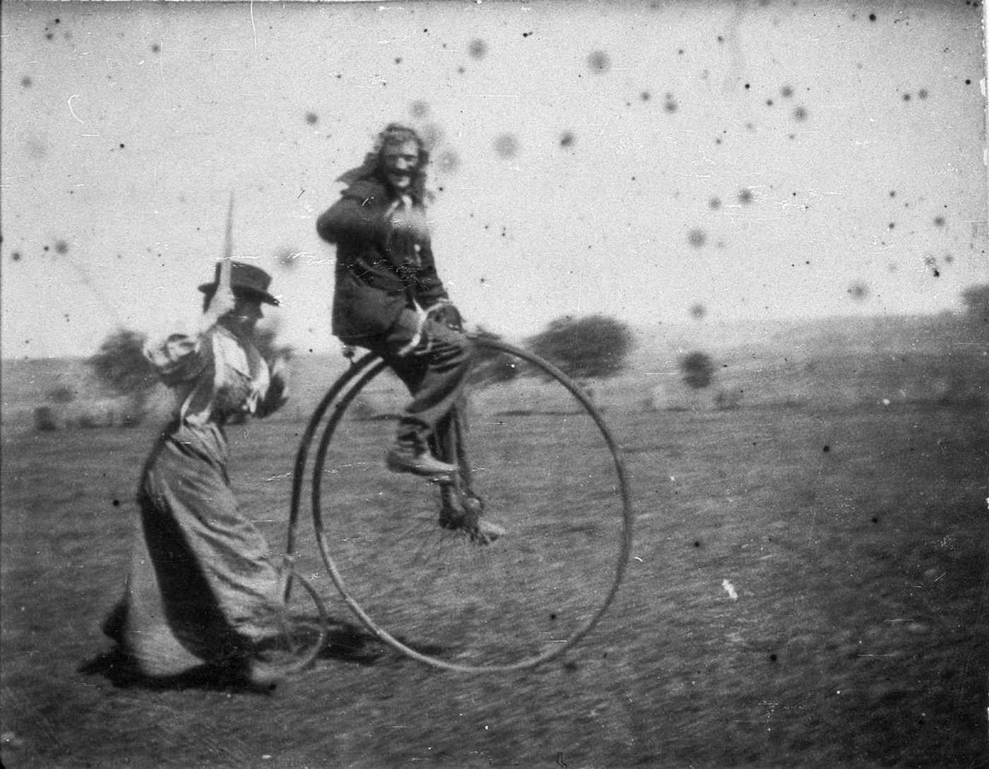 Man on a penny-farthing being chased by his sister