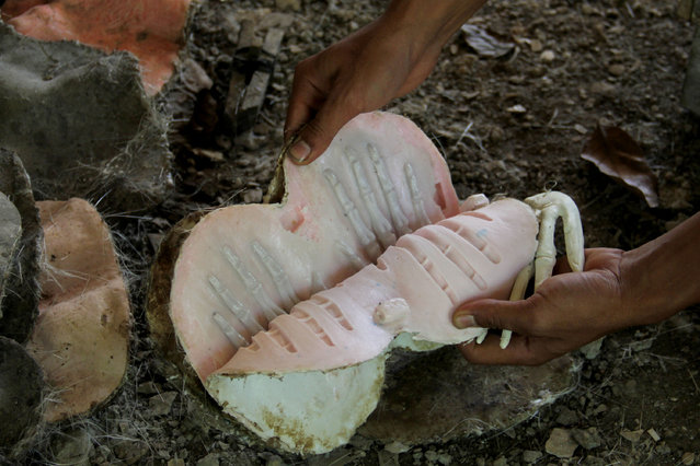 A craftsman makes molds of human hand bones