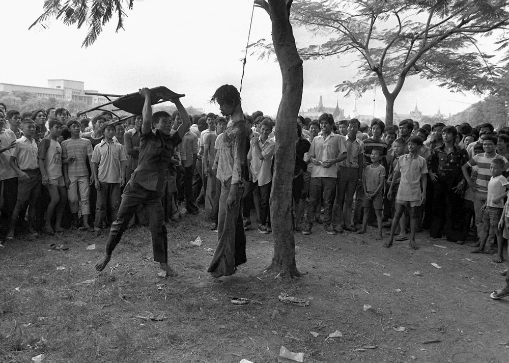 A member of a Thai political faction strikes at the lifeless body of a hanged student outside Thammasat University in Bangkok October 6, 1976