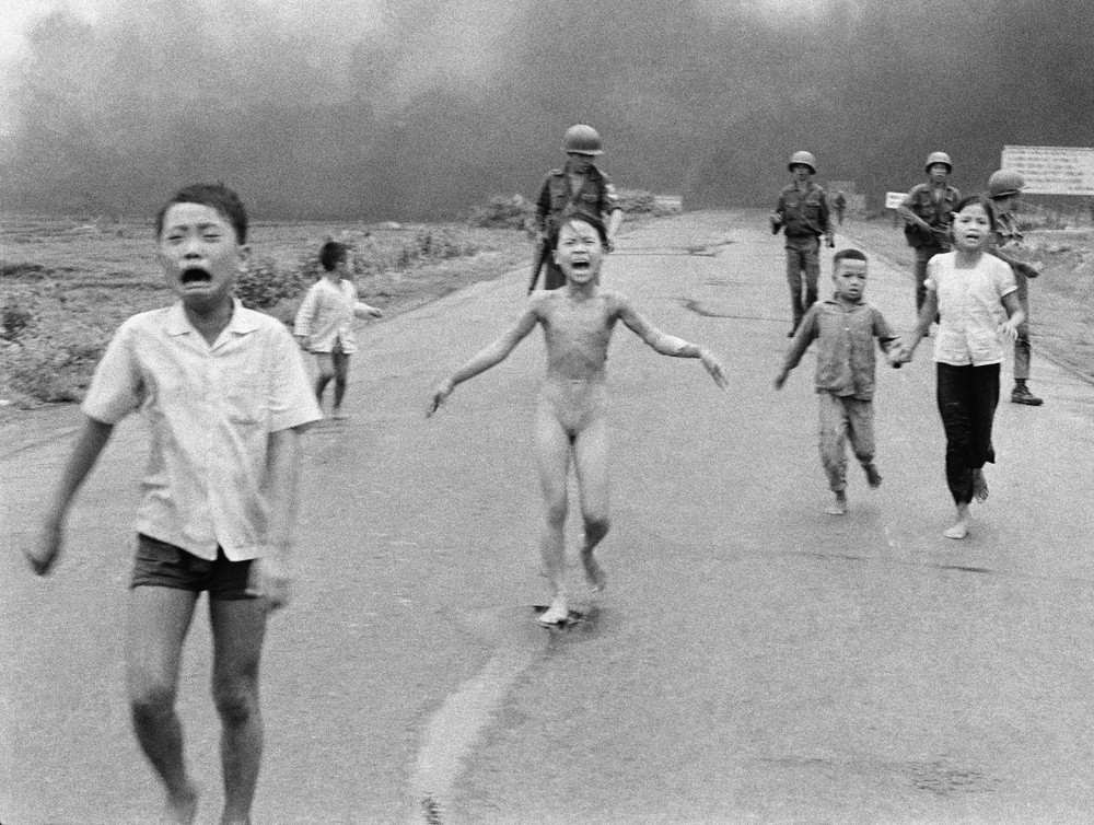 Terrified children, run down Route 1 near Trang Bang after an aerial napalm attack on suspected Viet Cong hiding places on June 8, 1972