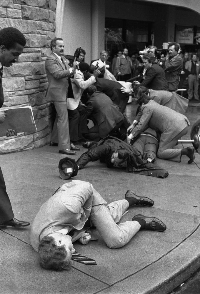 Thomas K. Delehanty, James Brady, background, lie wounded on a street outside a Washington hotel after shots were fired at U.S. President Reagan on March 30,1981