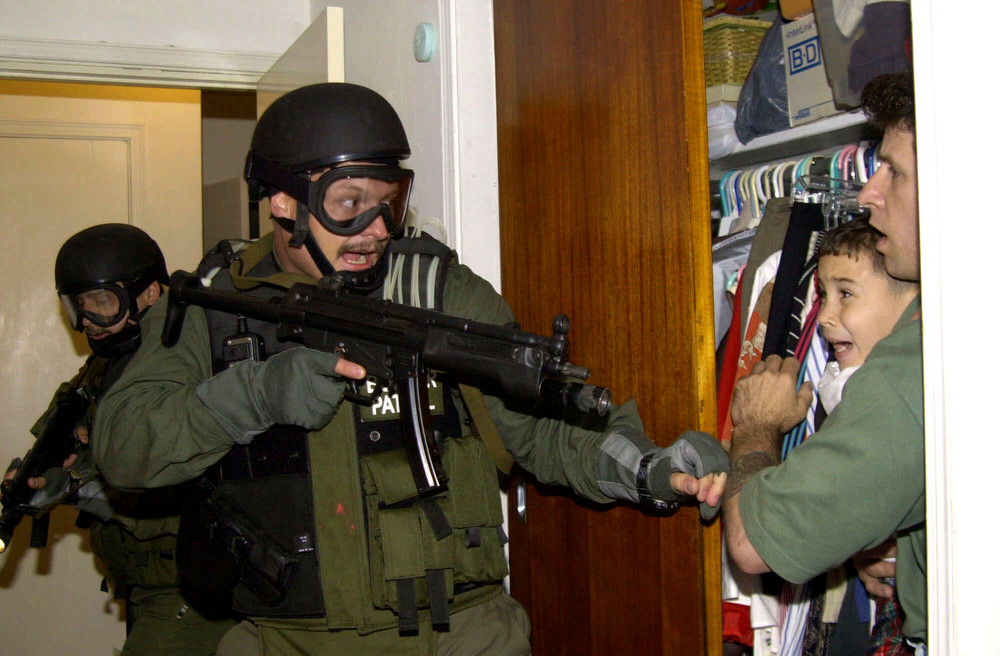 Elian Gonzalez is held in a closet by Donato Dalrymple, one of the two men who rescued the young boy, early morning, April 22, 2000
