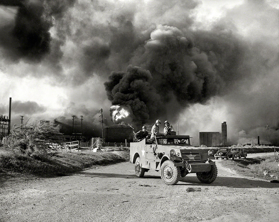 Armed troops block off a road near an explosion at an oil factory, Texas. April 17, 1947