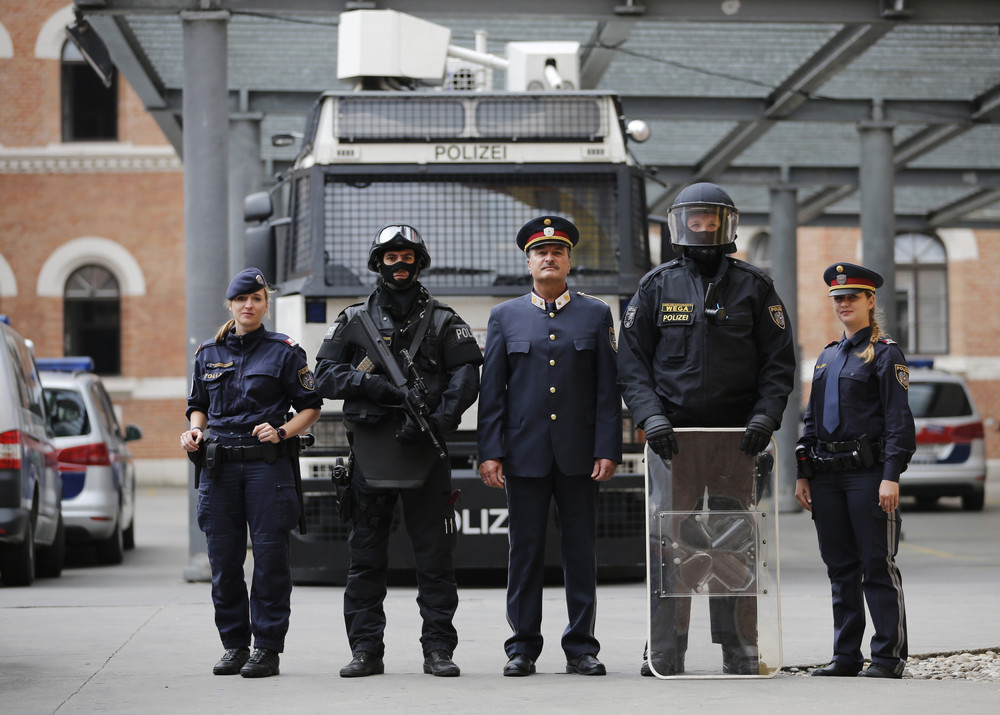 Austrian police officers pose in various uniforms