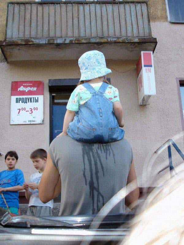 kid pees on dad's shoulders