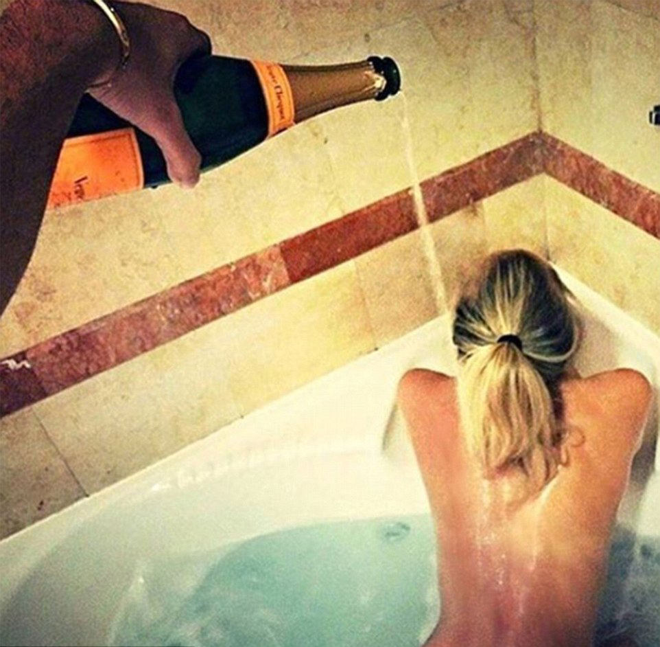 A real bubble bath! A lithe blonde is showered with a bottle of expensive champagne