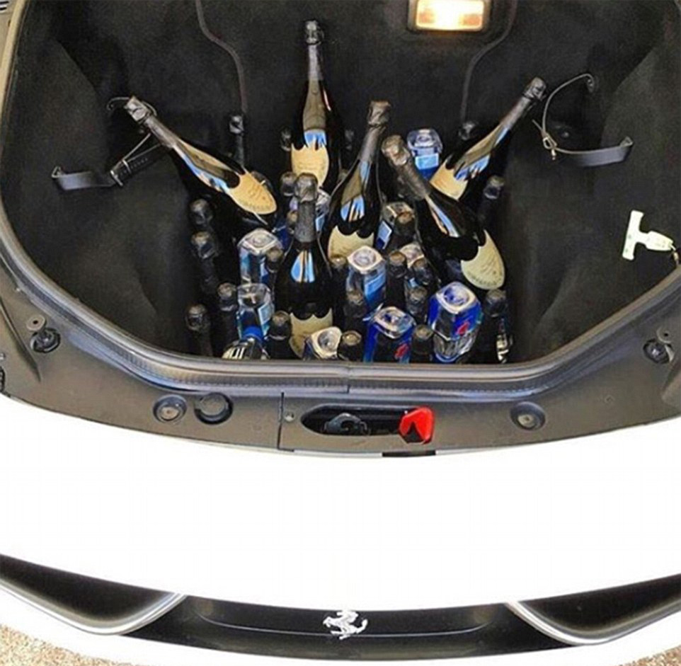 Boozy booty: A stash of Dom Pérignon champagne is secreted in a Ferrari, ready for a party