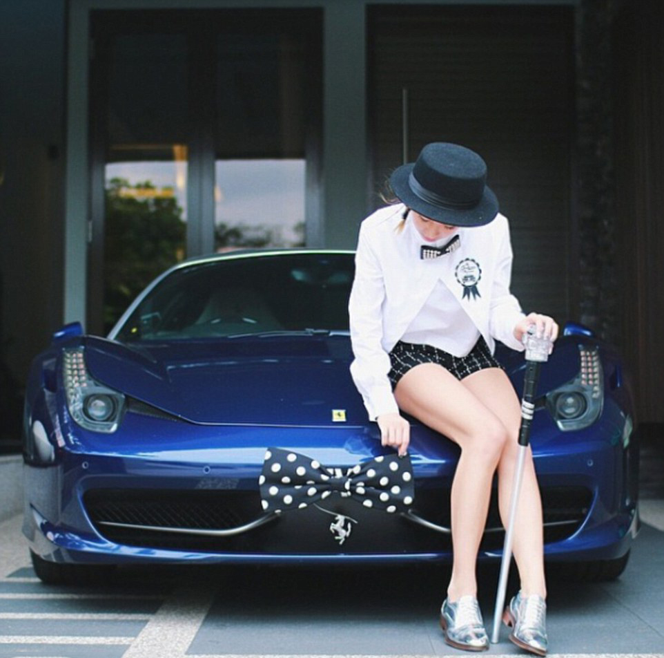 Taking a bow: This wealthy woman has dressed her Ferrari up in a matching outfit to her own