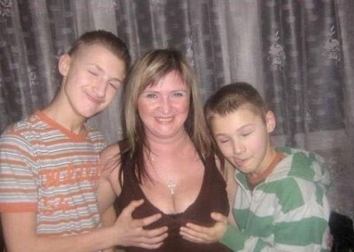 Mom and her two kids holding her boobs.