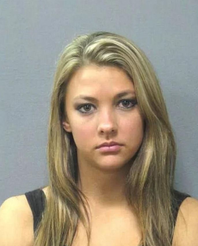 Clearly not happy with her charges this accused woman hasn't cracked a smile but still shows off stunning good looks