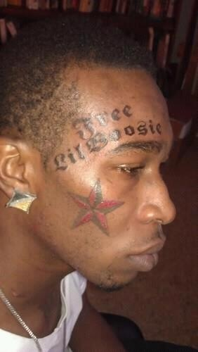 A guy gets a facial tattoo of a male rapper 