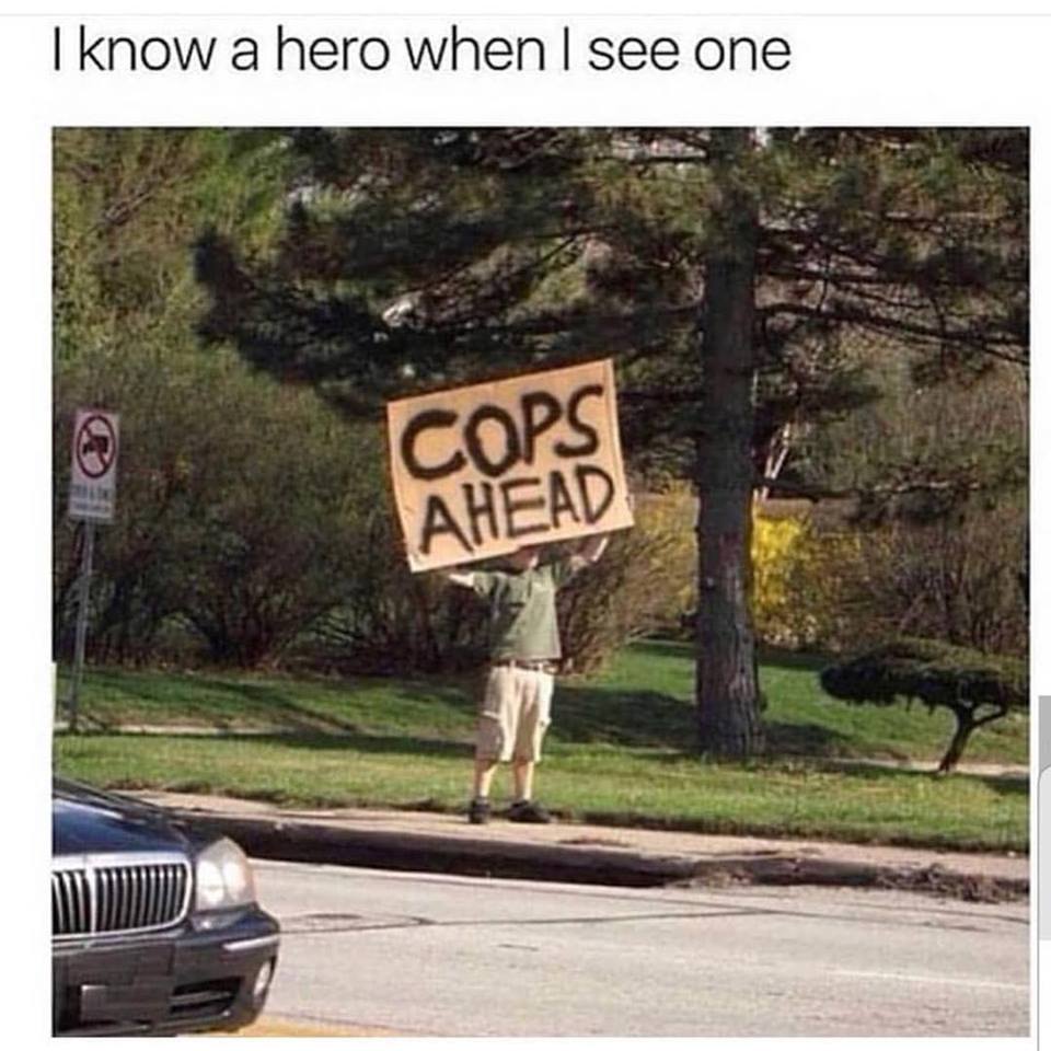 man with sign saying COP AHEAD