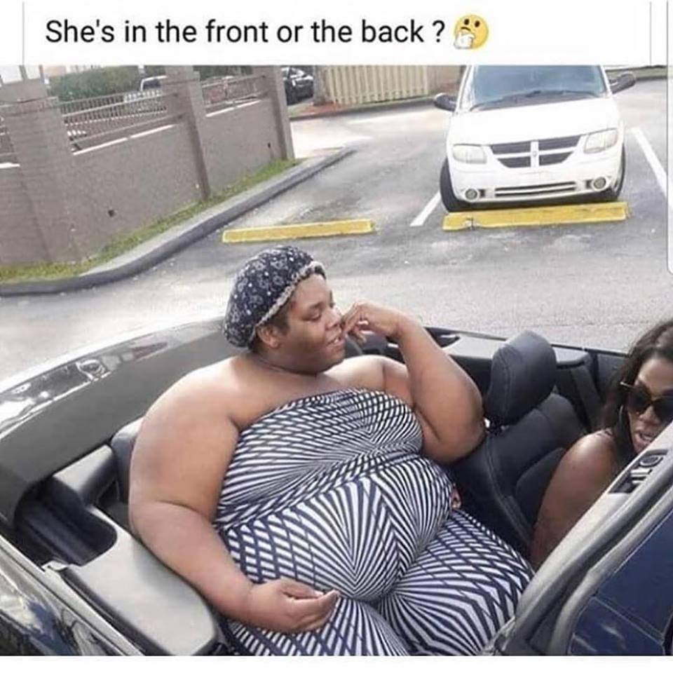 large woman sitting in a convertible that might be the back seat at that point