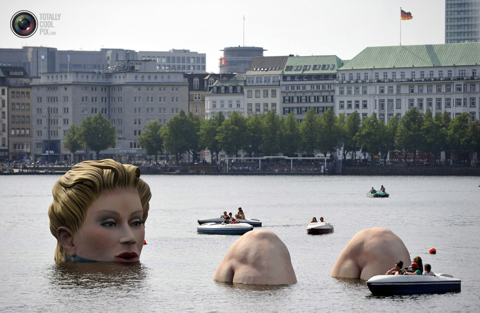 Boats gather around a sculpture of a mermaid, a four-meter-high sculpture made by Oliver Voss at the 'Alster' lake in Hamburg.