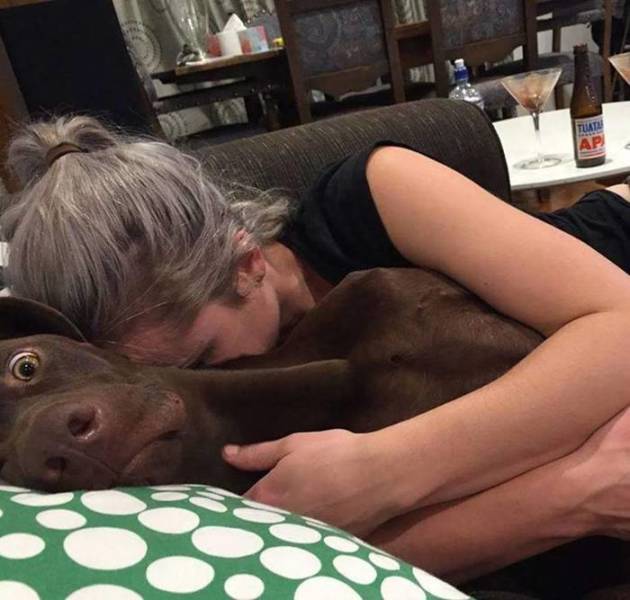woman cuddling with a dog