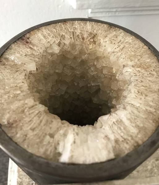 Six months of buildup in a pipe used for a mineral pool spa