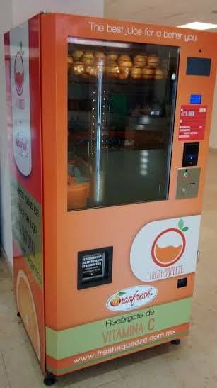 This machine squeezes fresh orange juice right in front of your eyes