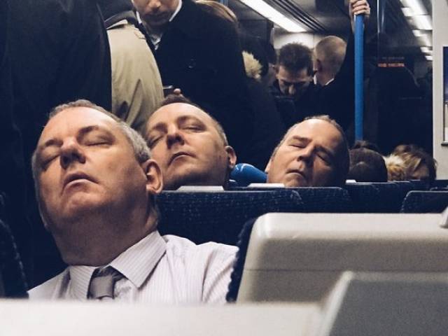 businessman asleep on a train daily