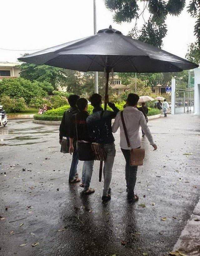 random picture of a group of friends walking under a massive umbrella