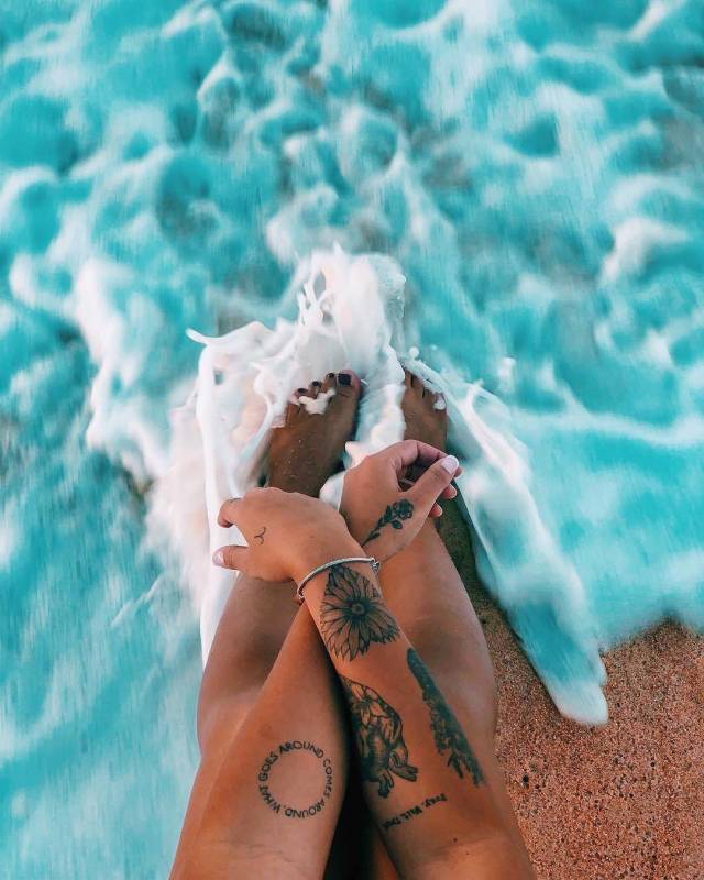 random picture of person with tattoos dipping their toes in the water