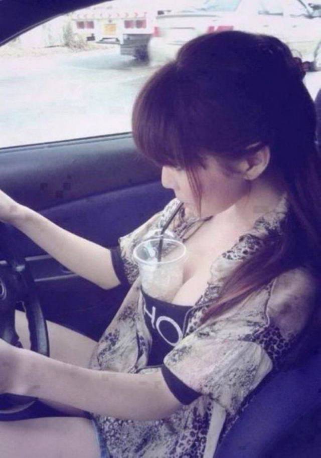 random picture of woman holding a cup with her breast to enjoy a beverage as she drives