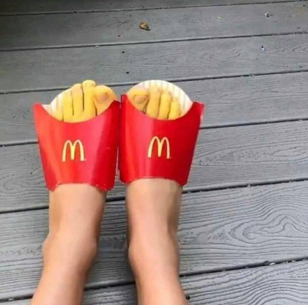 Cursed image of Feet in McDonald's fry containers with the toes painted yellow to look like french fries