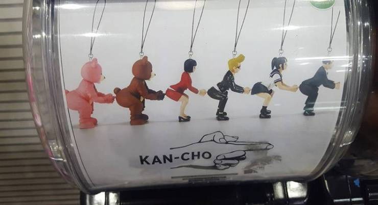 Cursed image of Kancho keychain charms that look like they're putting their hands up each others butts