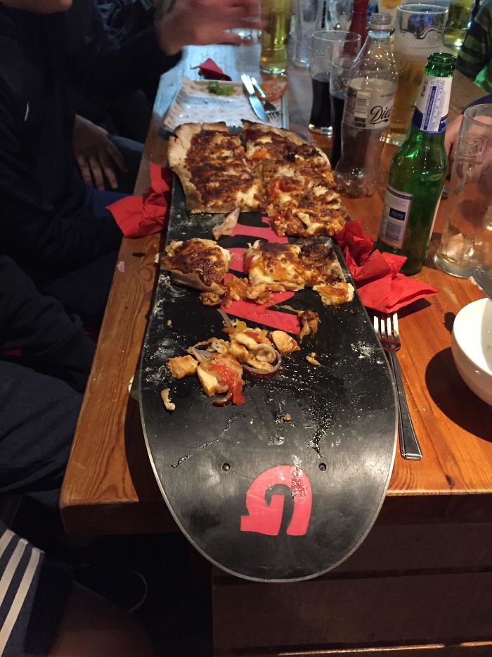 pizza served at a restaurant on a snowboard