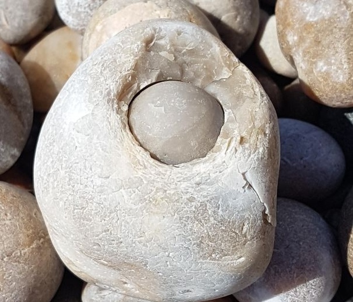 a rock with a smaller spherical rock inside it.