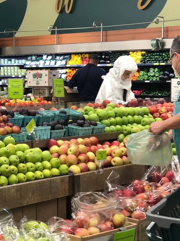 guy wearing full hazmat suit grocery shopping