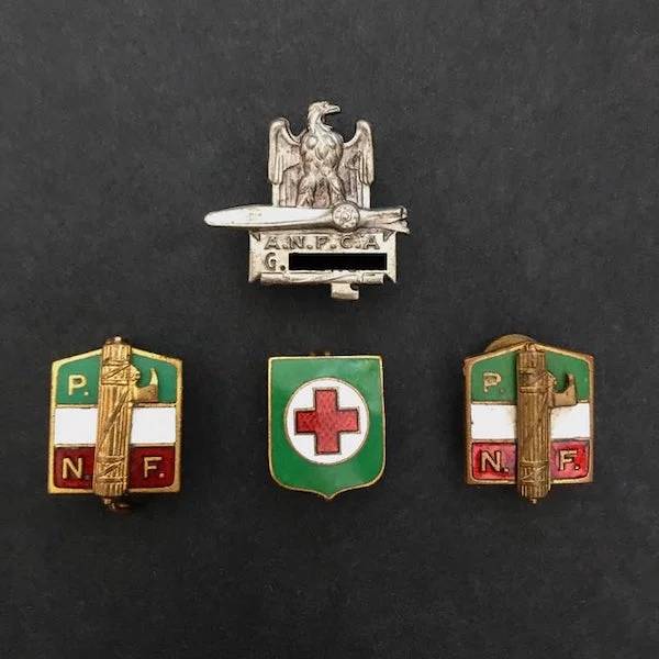 "In the pursuit of family history, I uncovered these amongst old family storage, untouched for decades. Belonged to my Great-Great Grandfather, however no one had info or history on them. Any ideas?"A: "Those are no doubt Italian pins. The PNF ones are National Fascist Party pins. The green one is Italian Voluntary Red Cross , possibly military related (this one I’m not 100% on but its definitely red Cross) The eagle one is Royal Airforce. All likely issued around the time Mussolini was around."