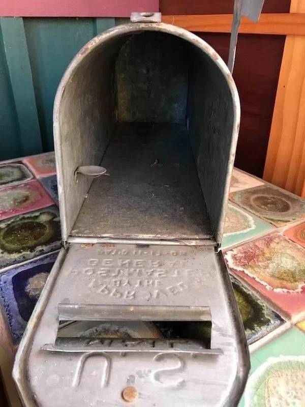 "Small round “shelf” in old mail box"A: "Leave change for postal worker to add postage"