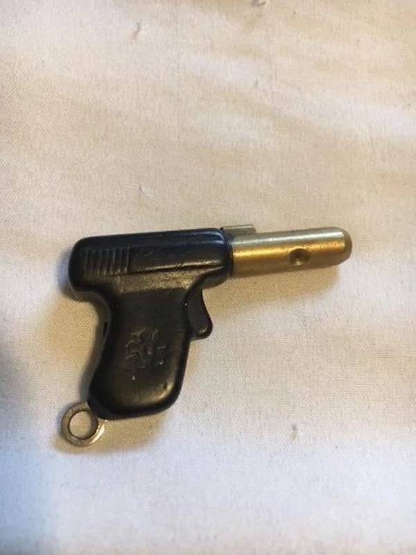 "Found in a Coinstar return slot. Looks like some type of key in the shape of a gun."A: "It is a gun keychain for a steering wheel lock"