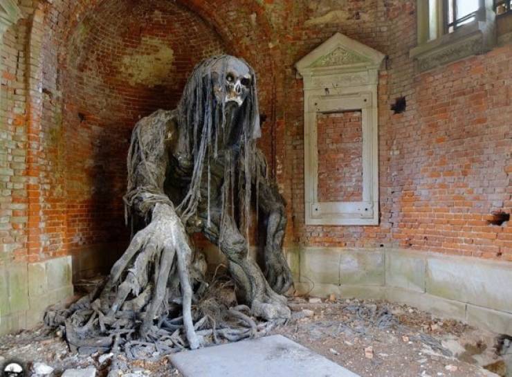 creepy statue in abandoned mausoleum in poland
