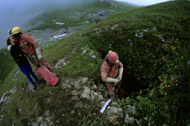 Why are these men wearing all that gear and kissing their loved ones goodbye just because they're going into that tiny, little pit in the ground? Because that is the opening to the world's deepest cave.