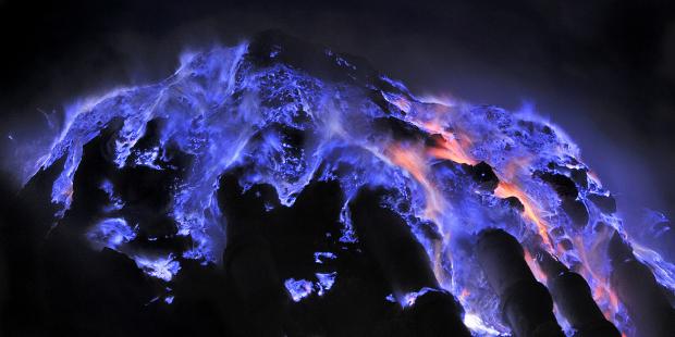 The lava of Kawah Ijen volcano in Indonesia glows a luminescent bright blue, like the flames of Hades reaching through the earth's crust.