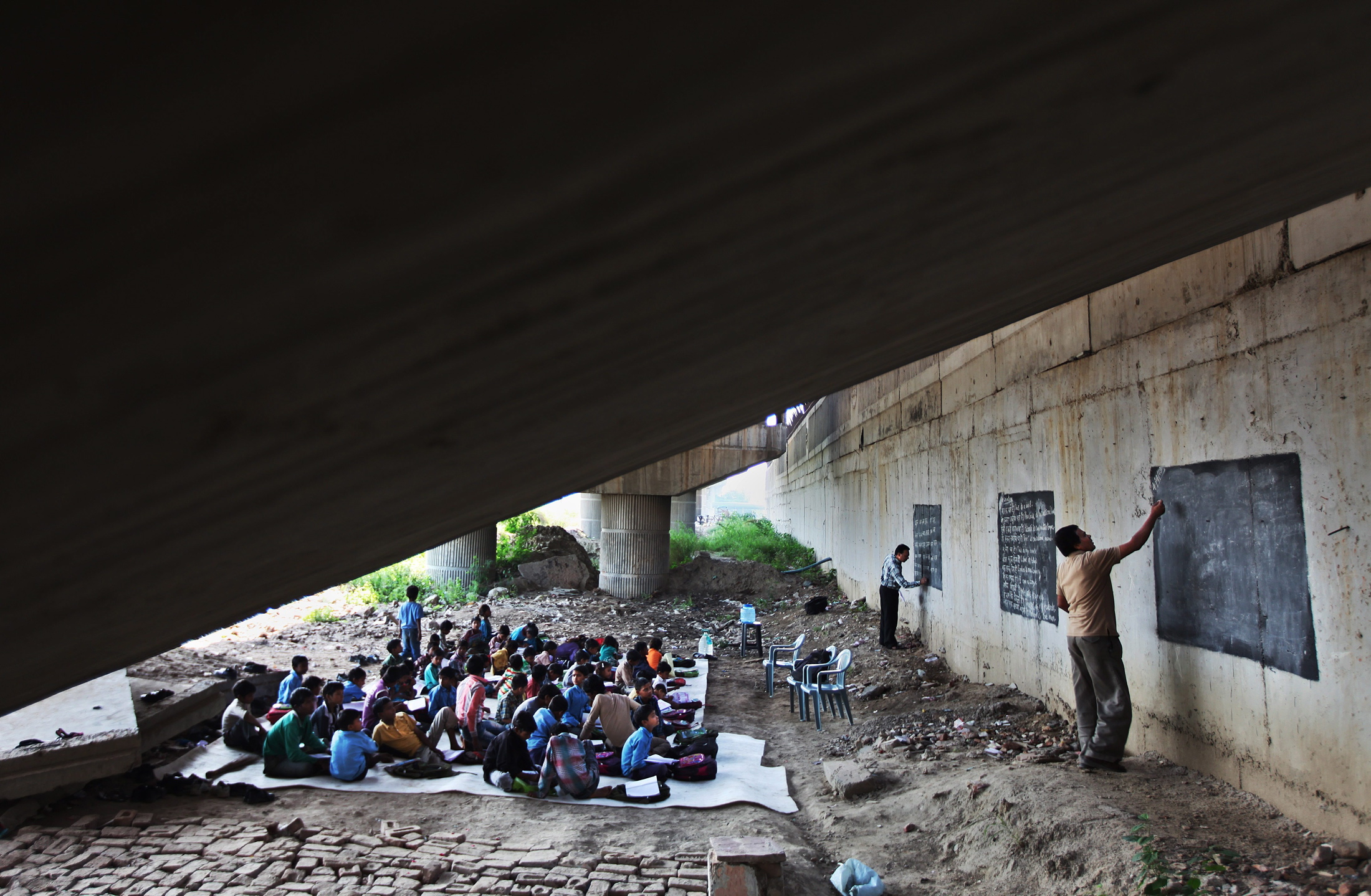 Laxmi Chandra, a postgraduate in science, teaches under the bridge as well.