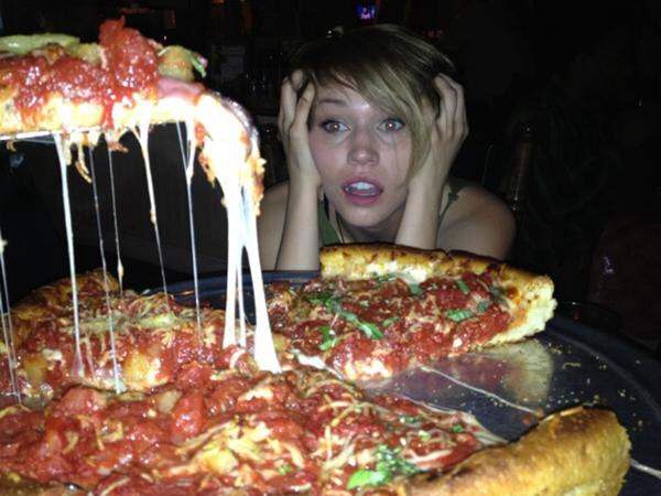 girl looking at pizza