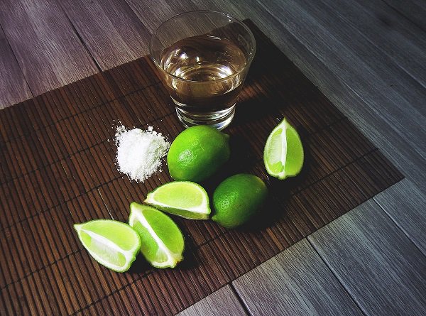 The ritual of involving salt and limes to shots of tequila started in the late 19th century because the taste of cheap tequila (which was being mass-produced at the time) was so god awful they needed a way to cope with it.