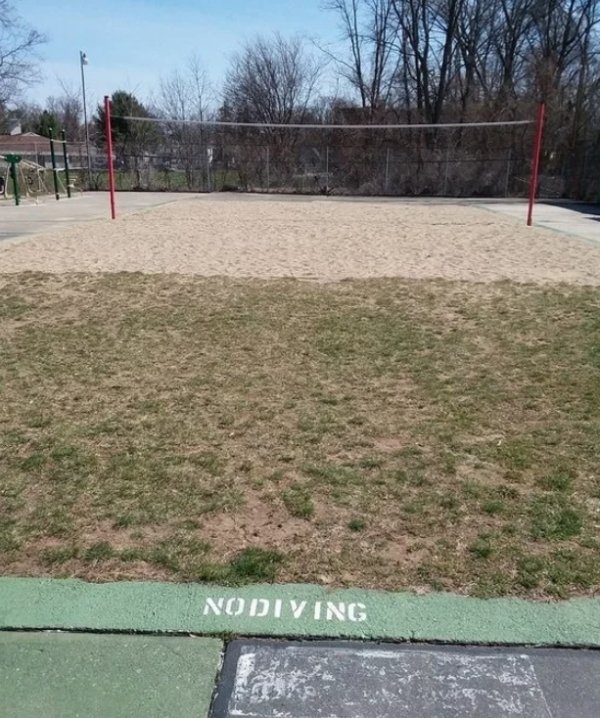 An old swimming pool made into a volleyball court.