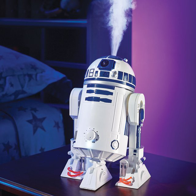 R2-D2 Humidifier –
This is the tabletop R2-D2 who remedies room dryness with a humidifier built into his domed head and he is only available from Hammacher Schlemmer. Stealthily quiet, this astromech droid employs ultrasonic technology to dispense a gentle soothing mist rather than the loud fans of lesser civilizations that can be heard far, far away. His resourceful body conceals a 1/2-gallon water tank that humidifies a room for up to 12 hours.