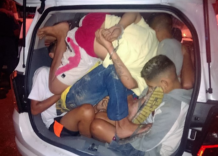 people sitting in a trunk of a car