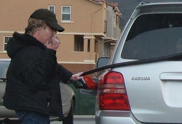 Having a smoke while pumping gas