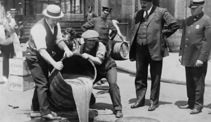 Prohibition begins and alcohol is poured down the drain in 1921.