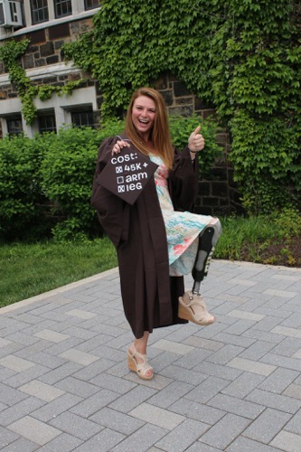 Girl about to graduate college with the costs of her education outlined on her gown.