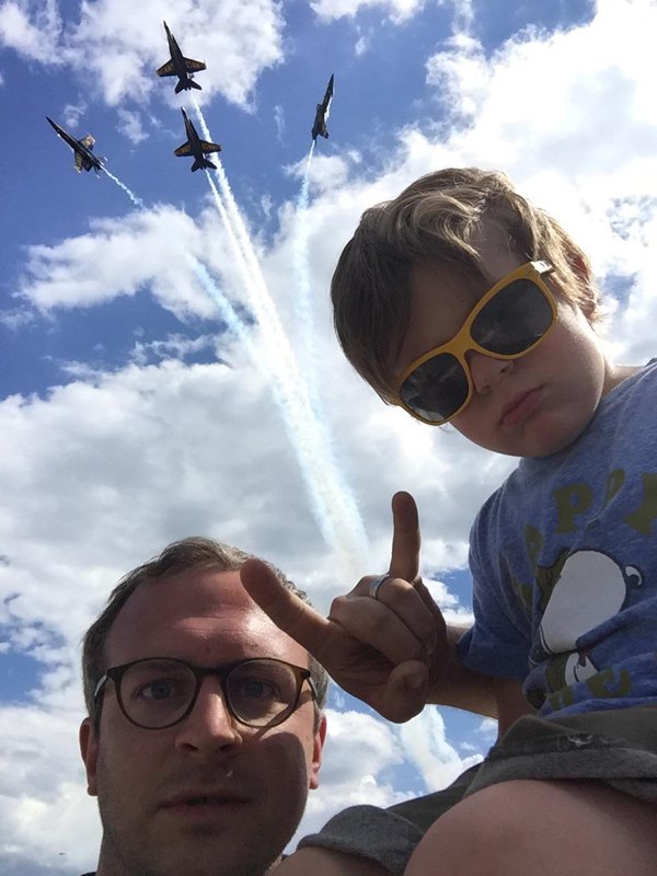 Awesome father and son pic of hanging loose sign with fighter jets breaking out of formation.