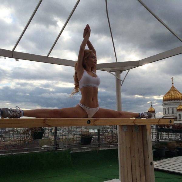 Girl doing splits on a balance beam